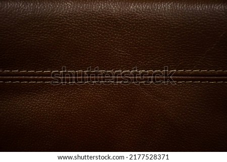 A leather background with a beautiful dark brown pattern and texture in a vintage tone.