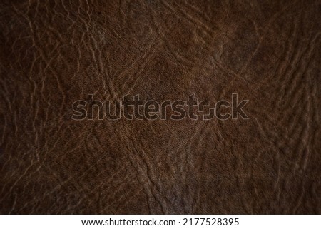 A leather background with a beautiful dark brown pattern and texture in a vintage tone.