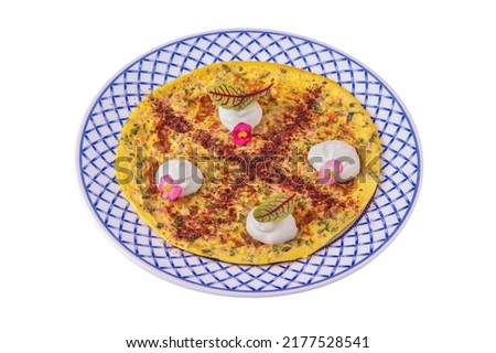 Omelet with sour cream, bacon, basil, violet and spices in a plate on a white background