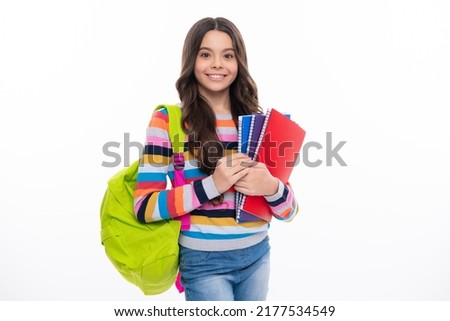 School teenager child girl 12, 13, 14 years old with school bag book and copybook. Teenager schoolgirl student, isolated background. Learning and knowledge. Positive and smiling emotions.