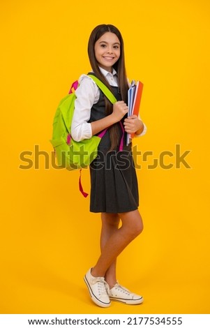 Back to school. Schoolgirl student with school bag backpack hold book on isolated studio background. School and education concept. Teenager girl in school uniform. Royalty-Free Stock Photo #2177534555