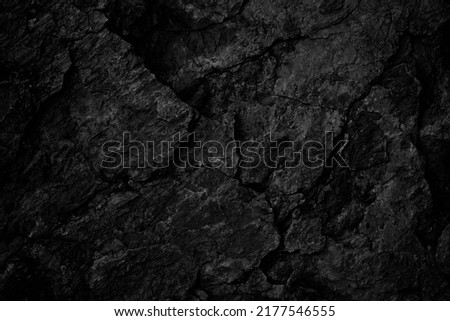  Black rock texture. Rough mountain surface with cracks. Close-up. Stone background with space for design.                              