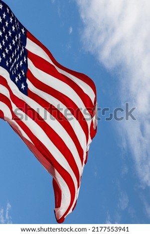 American flag hanging over mountain valley with the wind blowing