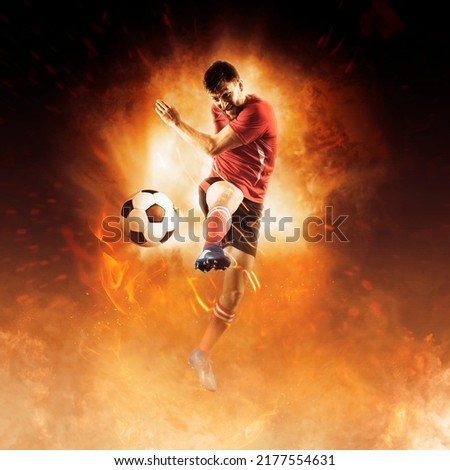 Soccer player in action on fire background Royalty-Free Stock Photo #2177554631