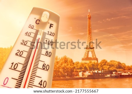 Thermometer in front of Paris skyline during heatwave in France
