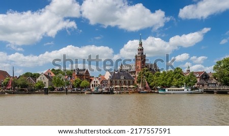 Leer, Germany. Panoramic view from Leda river on city hall, old weigh house in dutch classical baroque style, tourist harbor and bridge Royalty-Free Stock Photo #2177557591
