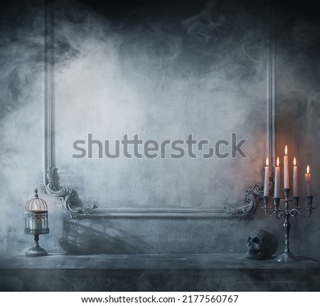 Mystical Halloween still-life background. Skull, candlestick with candles, old fireplace. Horror and witchery. Royalty-Free Stock Photo #2177560767