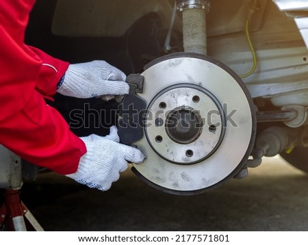 Process of replacing brake pads with Brand new. Auto mechanic repairing in garage Car brakes. Car Maintenance checklist Royalty-Free Stock Photo #2177571801