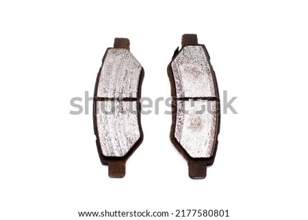 Very worn out brake pads threatening road safety isolated on white background.