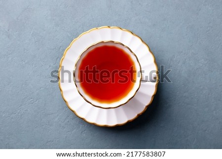 Tea in white cup. Grey background. Close up. Top view. Royalty-Free Stock Photo #2177583807