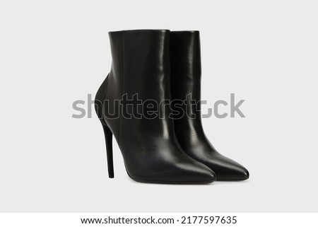 Black pointy toe women's ankle boots with high stiletto heels isolated on white background. Female classic, spring, autumn shoes. Blank casual leather footwear. Mock up, template Royalty-Free Stock Photo #2177597635
