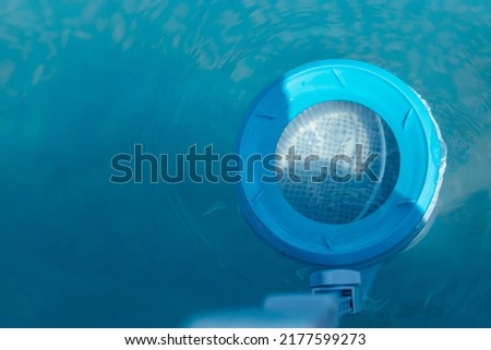 Top view of the skimmer for cleaning the pool in clear water. Close-up of the skimmer mounted on a frame pool Royalty-Free Stock Photo #2177599273