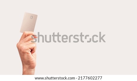 Banner with hand holding credit card mockup with chip. Contactless transactions, secure payments concept. Place for text. High quality photo