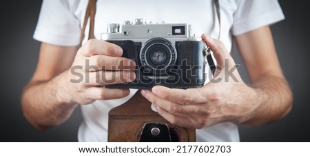 Man holding old retro camera.