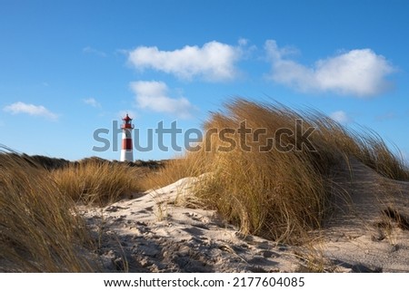 Panoramic image of List East lighthouse against blue sky, Sylt, North Frisia, Germany  Royalty-Free Stock Photo #2177604085