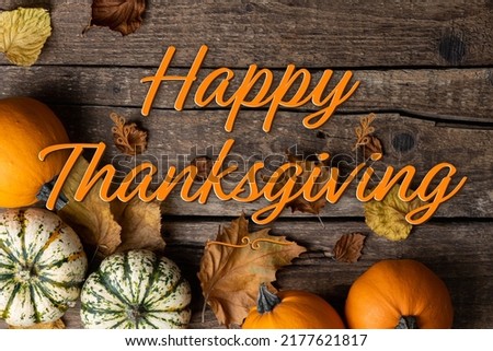 Happy Thanksgiving. Thanksgiving background with pumpkins and autumn leaves on rustic wooden background. Autumn composition - Thanksgiving greeting card
