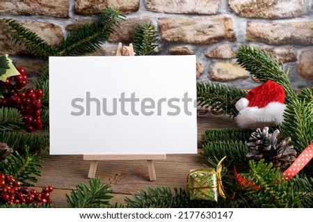Christmas landscape card mockup template with fir twigs and Christmas decoration on wooden background. Design element for Christmas and New Year congratulation, greeting or invitation card