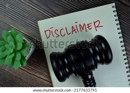 Concept of Disclaimer write on a book isolated on Wooden Table.