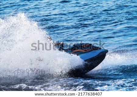 Jet ski close-up at speed, water splashes in different directions. The rider is not visible in the cloud of water droplets. Royalty-Free Stock Photo #2177638407