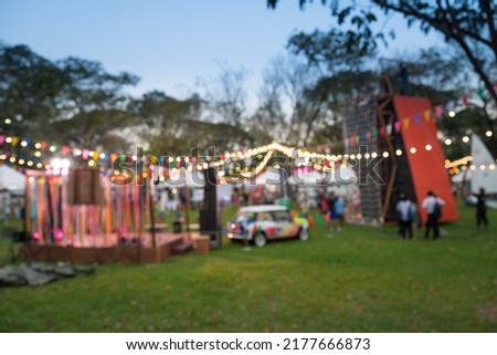 Abstract blur people in night outdoor festival city park backyard bokeh background. Outdoor festive, party and celebration concept. Royalty-Free Stock Photo #2177666873