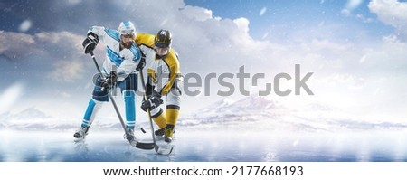 Two professional hockey players fight for the puck on ice. Hockey concept. Fight for the puck. Winter. Sports emotions. Hockey action. Sport