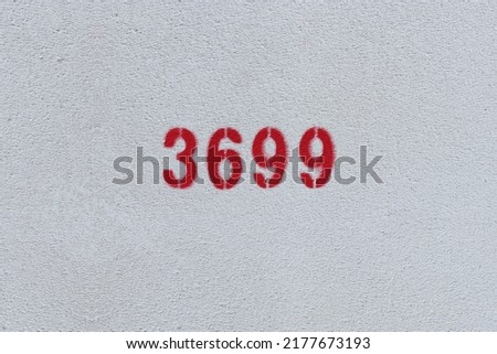 Red Number 3699 on the white wall. Spray paint.
