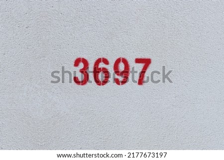 Red Number 3697 on the white wall. Spray paint.
