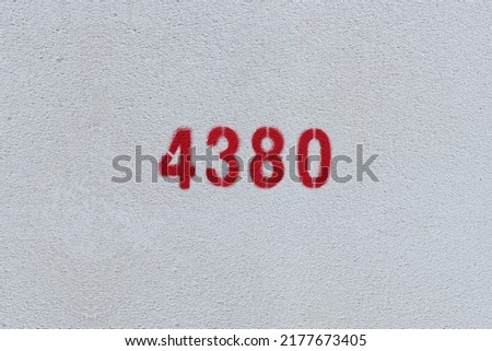 Red Number 4380 on the white wall. Spray paint.
