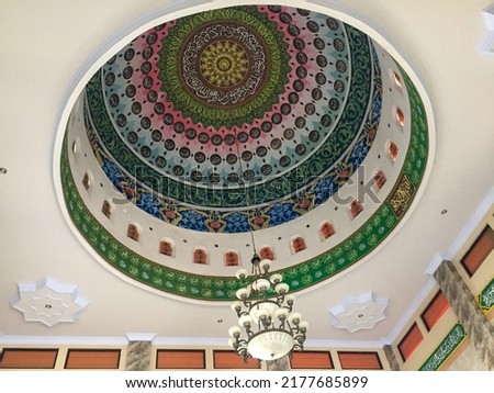 The architecture of the Asmaul Husna Mosque is colorful. Ornaments written in Arabic letters decorate the roof of the mosque.