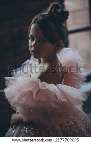 Little girl in a beautiful dress. Happy fashionable child. High quality photo