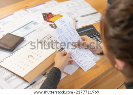 Financial owe asian woman, female sitting on floor home, stressed and confused by calculate expense from invoice or bill, have no money to pay, mortgage or loan. Debt, bankruptcy or bankrupt concept. Royalty-Free Stock Photo #2177711969