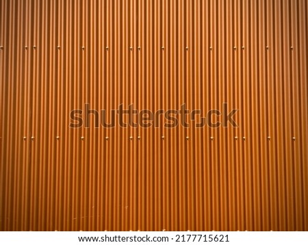 Photo of a orange metal corrugated wall
