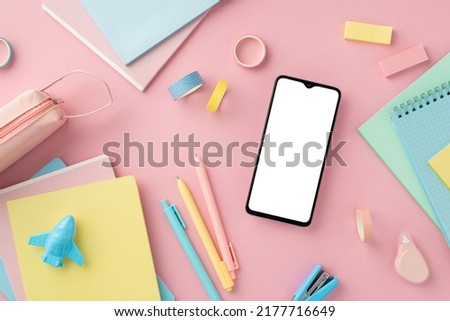 Back to school concept. Top view photo of smartphone notepads pens plane shaped sharpener adhesive tape stapler round correction tape pencil-case erasers on isolated pink background with copyspace