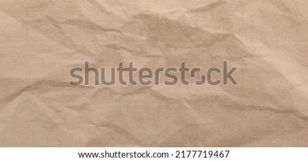 Craft crumpled paper, cardboard background. Brown kraft sheet texture, torn antique page, wallpaper or parchment abstract design, Horizontal rough carton, old material Realistic 3d vector illustration Royalty-Free Stock Photo #2177719467