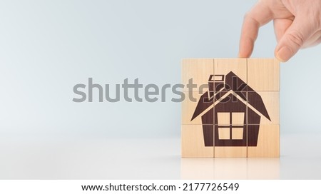 house on wooden cubes. business card or advertisement for real estate developer or construction company. Concept of construction, real estate. House icon on wooden cube blocks. copy space