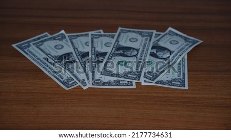 one American dollars on wooden background