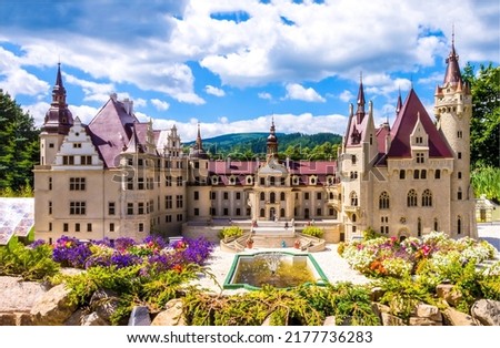 A beautiful fairytale castle with a park and a fountain. Castle palace exterior. Fairytale castle palace landmark. Castle palace view Royalty-Free Stock Photo #2177736283