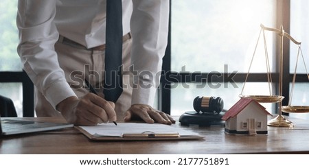 Close up lawyer businessman working or reading lawbook in office workplace for consultant lawyer concept.
