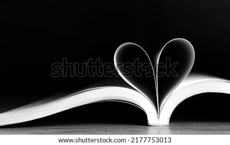 
The book was opened in the middle. then folded down to form a heart with a black background to convey the mood of love that is not bright , focus on the center of the heart
 Royalty-Free Stock Photo #2177753013