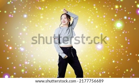 Asian female dancer dancing on stage. Royalty-Free Stock Photo #2177756689