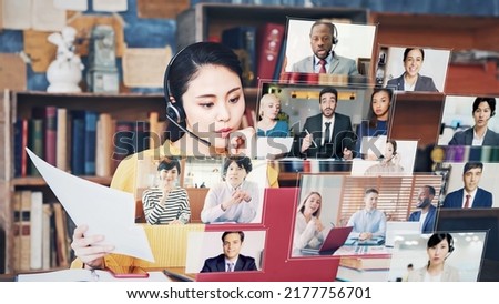 Young Asian woman taking video conference. Online meeting. Hologram screens. Royalty-Free Stock Photo #2177756701