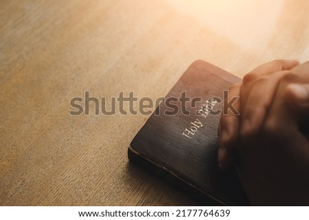 Christian Crisis Prayer to God Man praying to God for a better life human hands praying to god with bible believe in good Hold hands and pray. Royalty-Free Stock Photo #2177764639