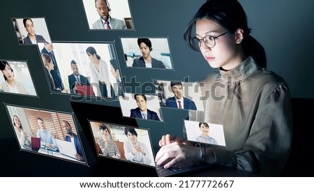 Young Asian woman taking video conference. Online meeting. Hologram screens. Royalty-Free Stock Photo #2177772667