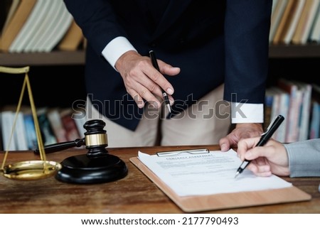 Business woman and lawyers discussing contract papers with brass scale on wooden desk in office. Law, legal services, advice, Justice concept