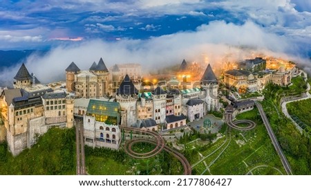 Aerial view of landscape is castles covered with fog at the top of Bana Hills, the famous tourist destination of Da Nang, Vietnam. Near Golden bridge. Panorama French village Royalty-Free Stock Photo #2177806427
