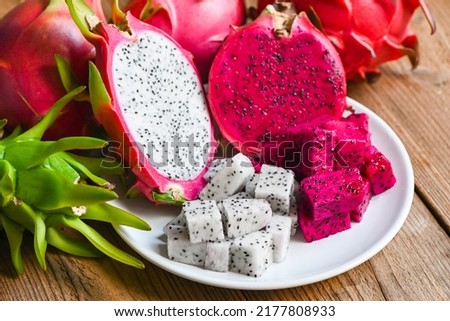 fresh white and red purple dragon fruit tropical in the asian thailand healthy fruit concept, dragon fruit slice and cut half on white plate with pitahaya background