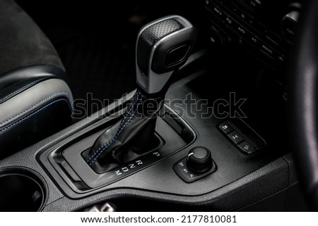 automatic transmission shift selector in the car interior. Closeup a manual shift of modern car gear shifter. 4x4 gear shift Royalty-Free Stock Photo #2177810081