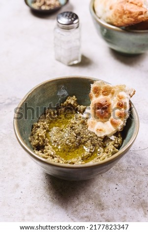 Babaganush or eggplant hummus from baked eggplant. Turkish eggplant dip baba ghanoush served with olive oil, pepper and oriental flatbreads. Selective focus Royalty-Free Stock Photo #2177823347