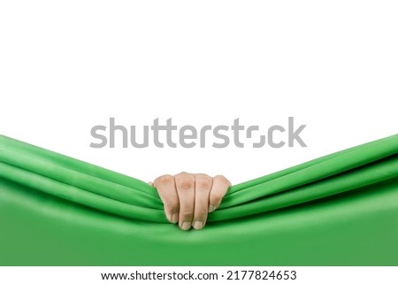 Human hand opening green curtain with white background Royalty-Free Stock Photo #2177824653