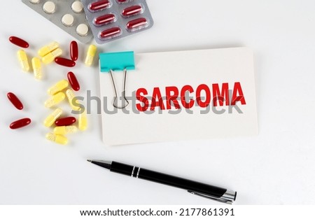 SARCOMA text written in card with pills. Medical concept.